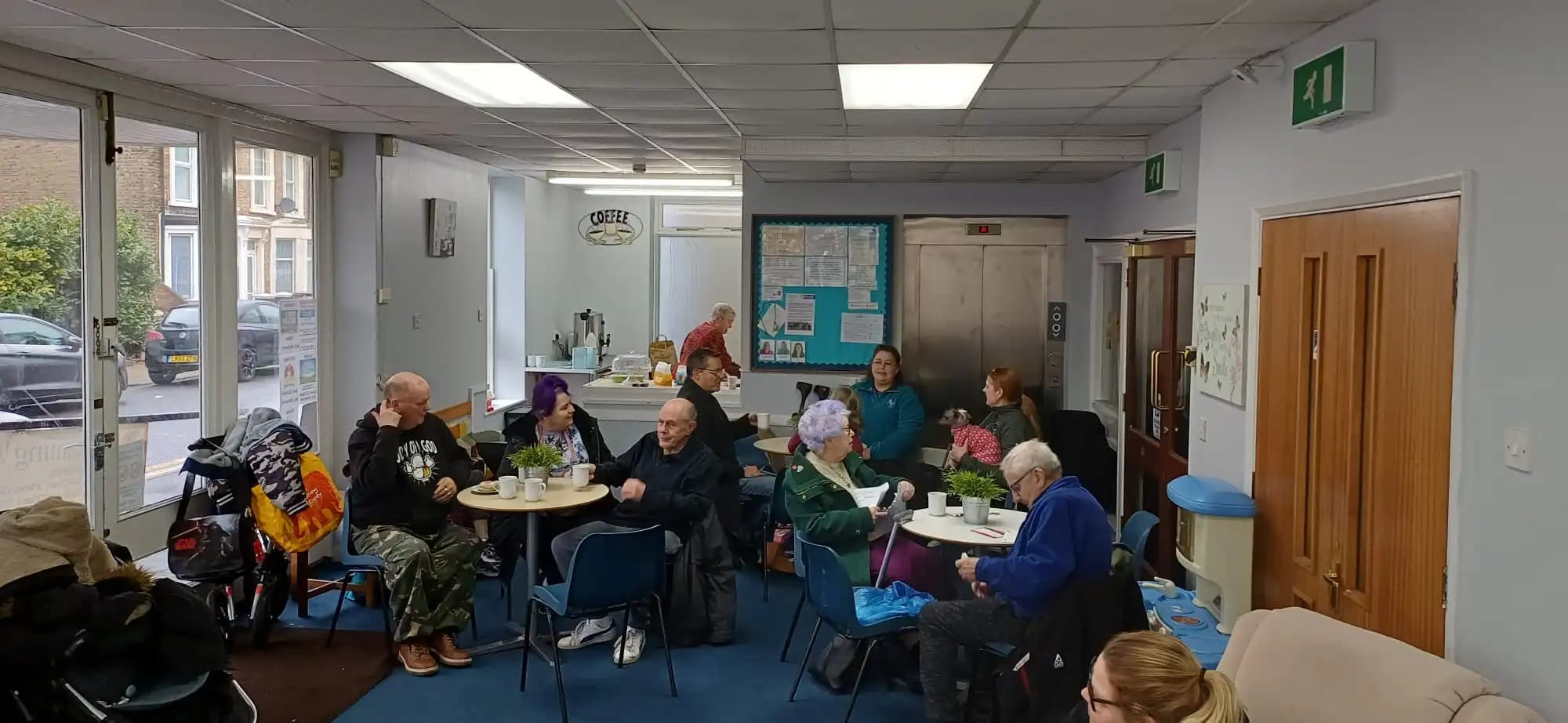 People sharing conversation around tables at a community gathering