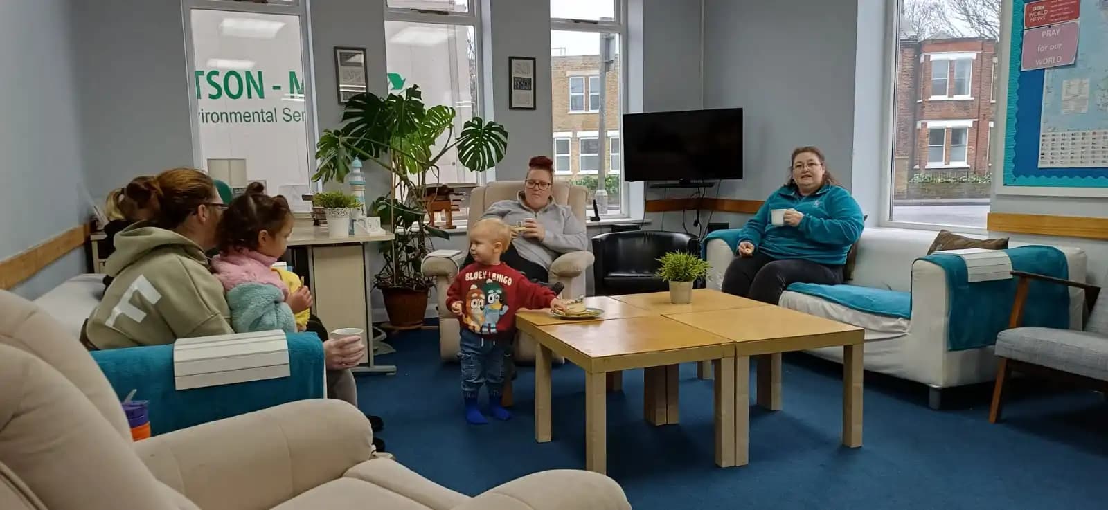 A welcoming group of people seated together in a bright community room